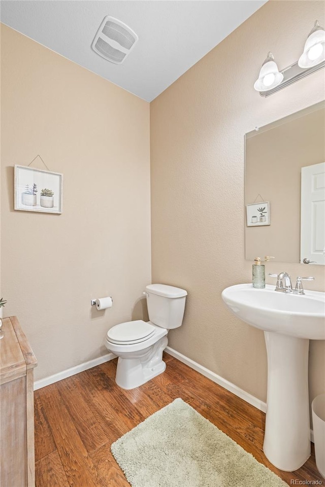 9530 Gray St, Westminster, CO 80031 - half bath featuring wood finished floors and toilet