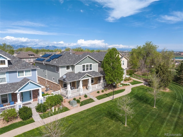 9530 Gray St, Westminster, CO 80031 - view of front of house featuring covered porch, stone siding, a front yard, and a residential view