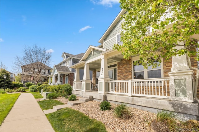 9530 Gray St, Westminster, CO 80031 - view of side of property with a porch and brick siding
