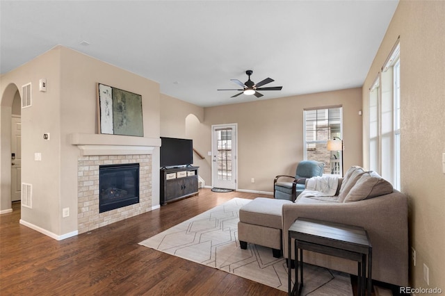 9530 Gray St, Westminster, CO 80031 - living area with arched walkways, ceiling fan, wood finished floors, and a brick fireplace