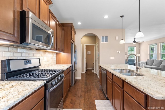 9530 Gray St, Westminster, CO 80031 - kitchen with stainless steel appliances, arched walkways, tasteful backsplash, recessed lighting, and dark wood finished floors