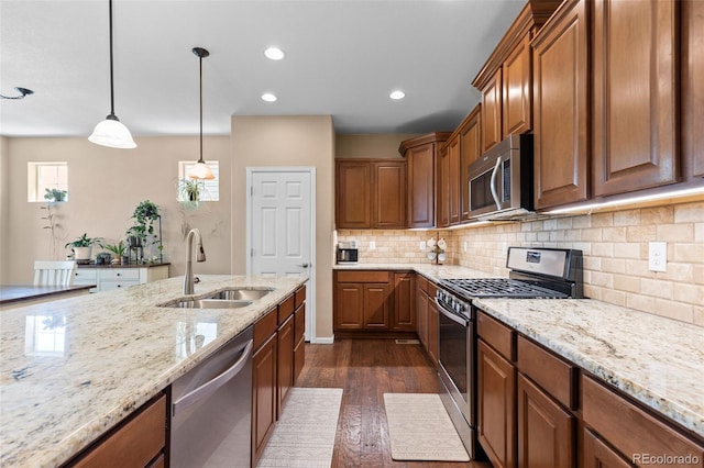 9530 Gray St, Westminster, CO 80031 - kitchen featuring stainless steel appliances, dark wood finished floors, brown cabinetry, light stone countertops, and recessed lighting