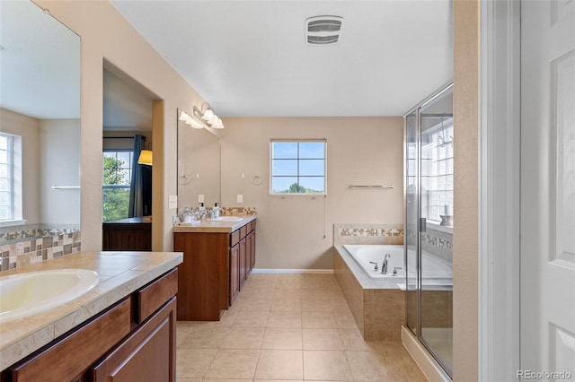 9530 Gray St, Westminster, CO 80031 - full bath featuring healthy amount of natural light, two vanities, tile patterned flooring, and a bath