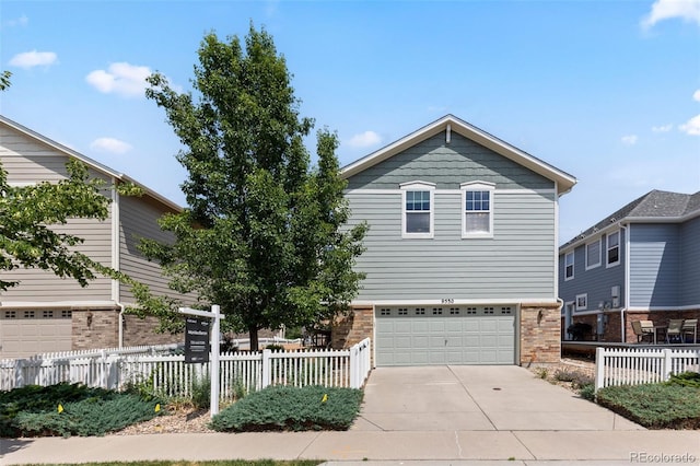 9530 Gray St, Westminster, CO 80031 - view of front of house with brick siding, driveway, and a garage