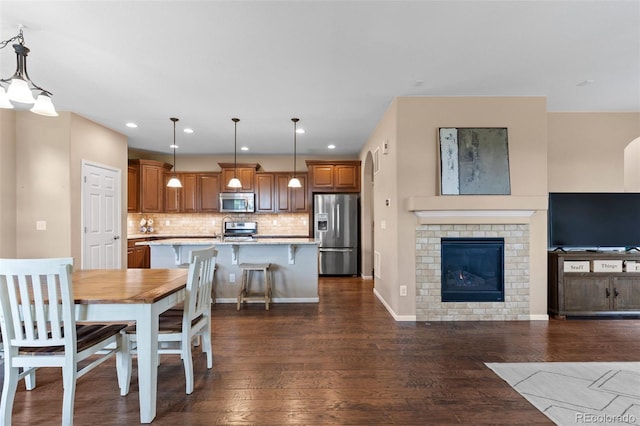 9530 Gray St, Westminster, CO 80031 - dining space with dark wood finished floors, recessed lighting, and a brick fireplace
