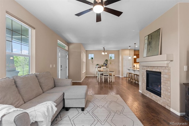 9530 Gray St, Westminster, CO 80031 - living area featuring wood finished floors, a ceiling fan, and a fireplace
