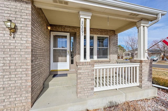 view of exterior entry featuring a porch