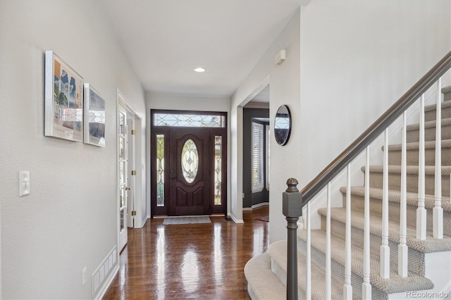 entryway featuring visible vents, baseboards, stairs, recessed lighting, and wood finished floors