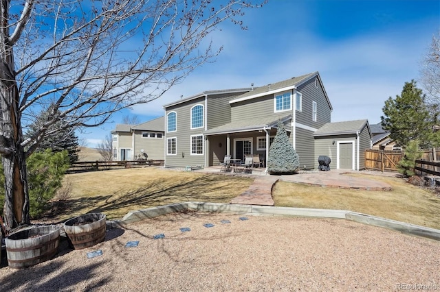 rear view of house with a patio area, a yard, and fence private yard