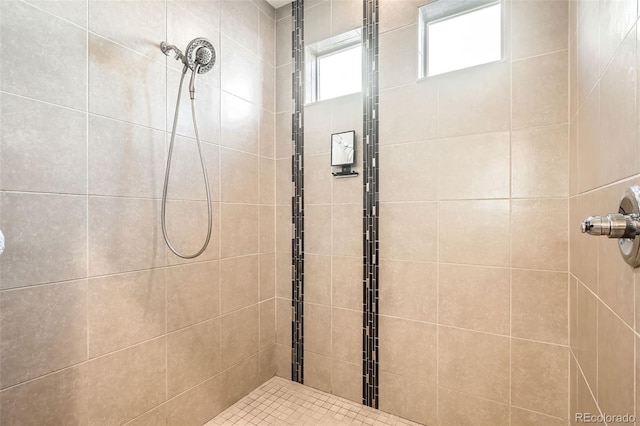 bathroom with a tile shower