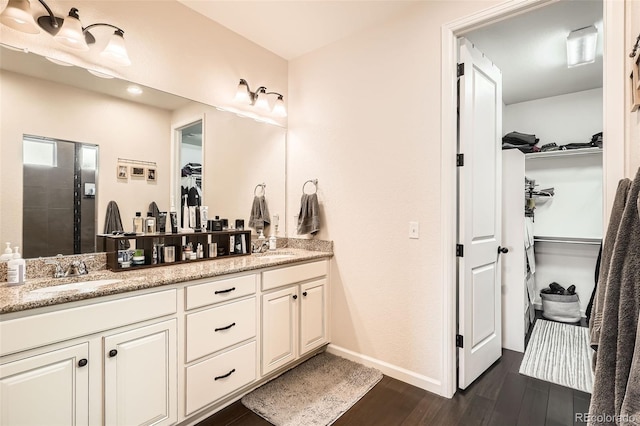 bathroom featuring vanity, hardwood / wood-style floors, and walk in shower