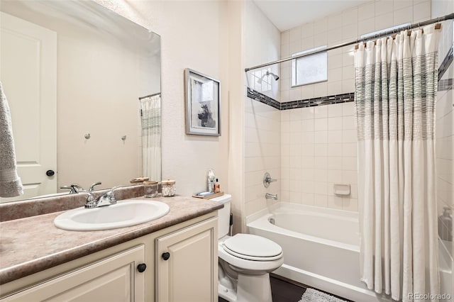 full bathroom with shower / tub combo with curtain, vanity, and toilet