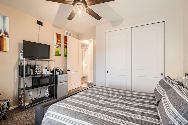 carpeted bedroom with a closet and ceiling fan