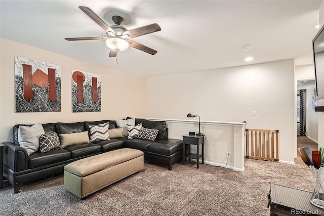 carpeted living room with ceiling fan