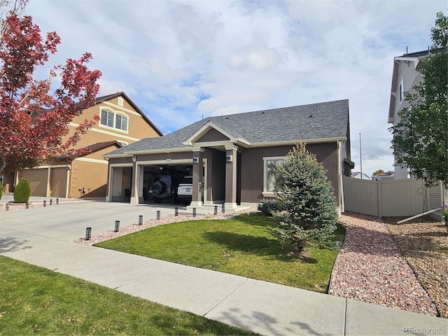 view of front of house featuring a garage and a front lawn