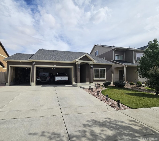 view of front of home with a garage and a front yard