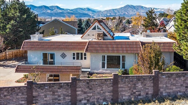 back of house with a mountain view