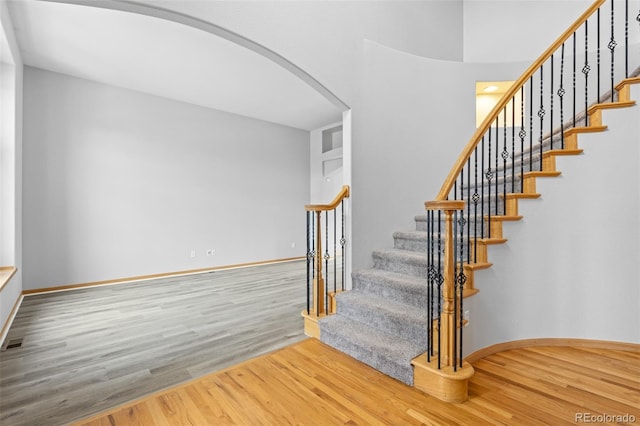 stairs with hardwood / wood-style flooring