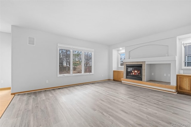 unfurnished living room featuring a fireplace and light wood-type flooring