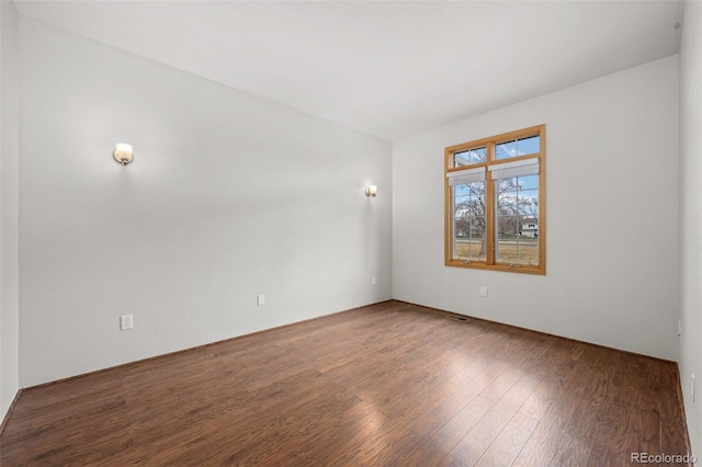 unfurnished room with wood-type flooring