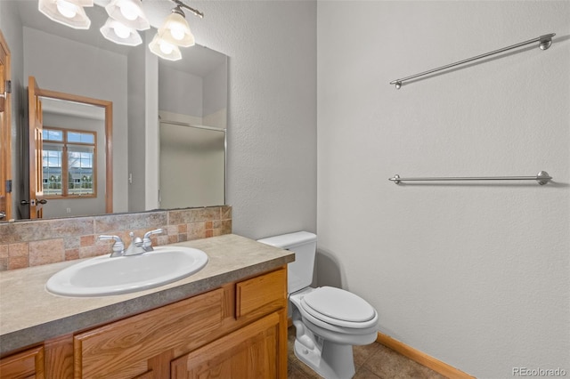 bathroom featuring vanity, tasteful backsplash, tile patterned floors, and toilet