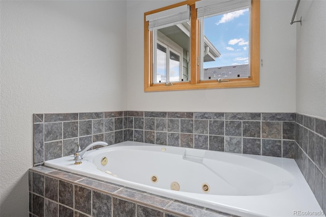 bathroom featuring tiled bath