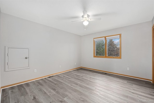 spare room with light hardwood / wood-style flooring and ceiling fan