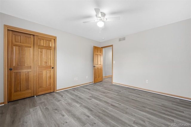 unfurnished bedroom with ceiling fan and light hardwood / wood-style floors