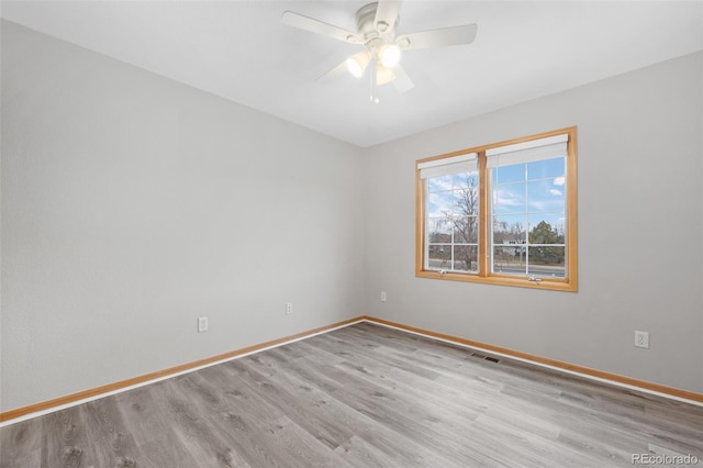 spare room with ceiling fan and light hardwood / wood-style floors