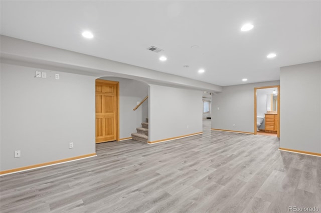 basement with light hardwood / wood-style flooring