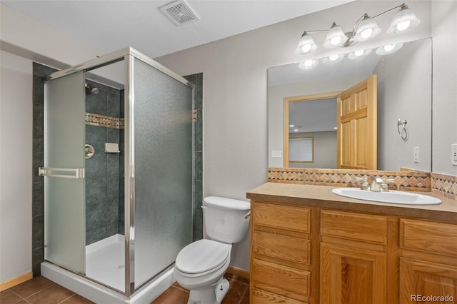 bathroom with walk in shower, tile patterned floors, toilet, vanity, and decorative backsplash