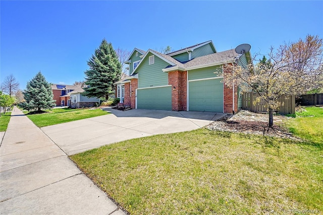 3173 Kingfisher Ct, Fort Collins, CO 80528 - view of front facade featuring concrete driveway, brick siding, fence, and a garage