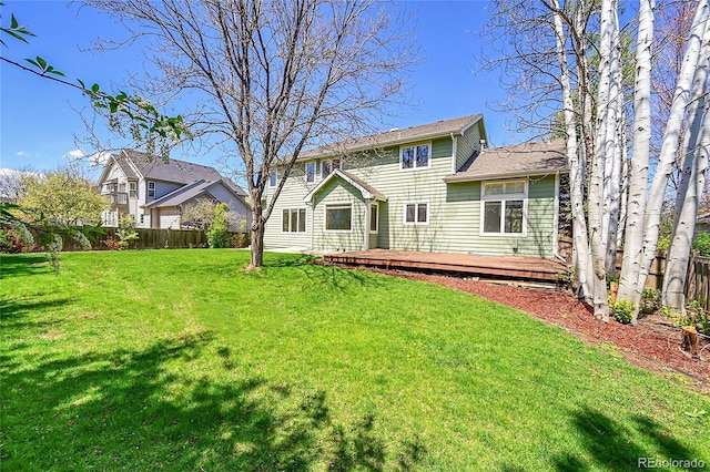 3173 Kingfisher Ct, Fort Collins, CO 80528 - rear view of house with a deck, a lawn, and a fenced backyard