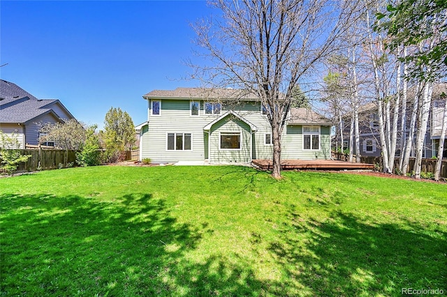3173 Kingfisher Ct, Fort Collins, CO 80528 - back of property with a lawn, a wooden deck, and a fenced backyard
