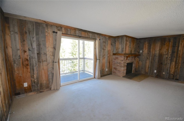 107 Peaks View Ct Unit 324, Blue River, CO 80424 - unfurnished living room featuring wood walls, carpet, a fireplace, and a textured ceiling