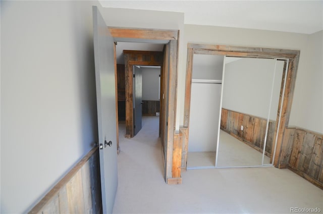 107 Peaks View Ct Unit 324, Blue River, CO 80424 - unfurnished bedroom with carpet, wooden walls, and a closet