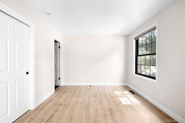 1530 S Quebec Way Unit 24, Denver, CO 80231 - unfurnished bedroom featuring light wood-style floors and baseboards