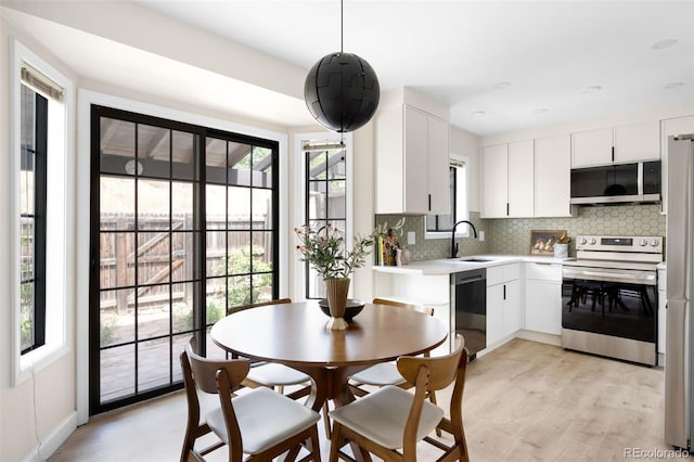 1530 S Quebec Way Unit 24, Denver, CO 80231 - dining space featuring light wood-style floors