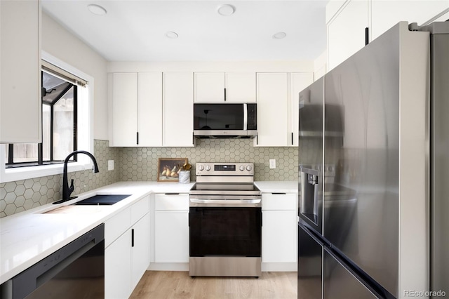 1530 S Quebec Way Unit 24, Denver, CO 80231 - kitchen with appliances with stainless steel finishes, white cabinetry, and light countertops