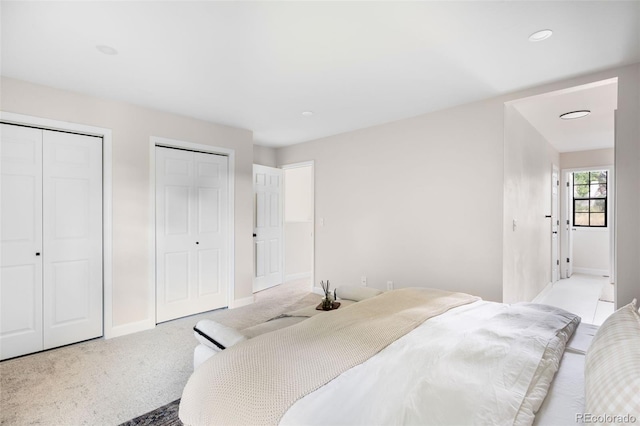 1530 S Quebec Way Unit 24, Denver, CO 80231 - carpeted bedroom featuring multiple closets and recessed lighting