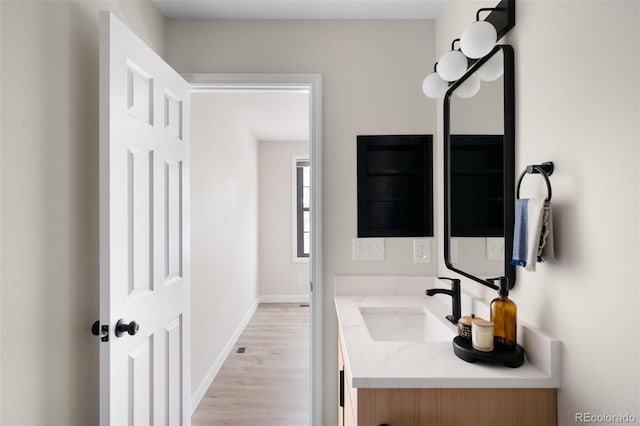 1530 S Quebec Way Unit 24, Denver, CO 80231 - bathroom featuring vanity and wood finished floors