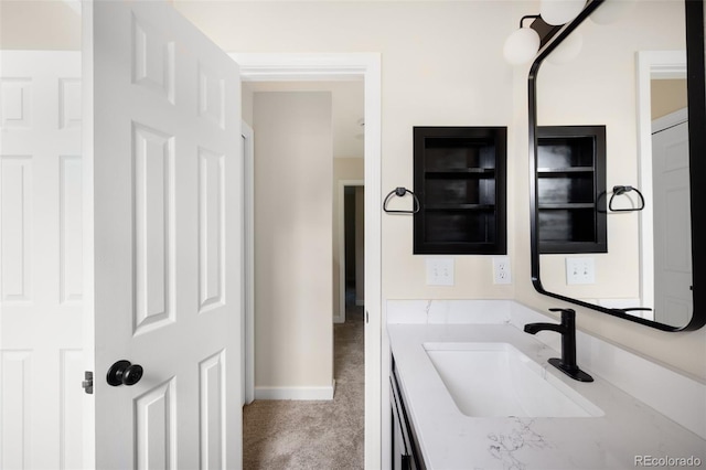 1530 S Quebec Way Unit 24, Denver, CO 80231 - bathroom with vanity and baseboards