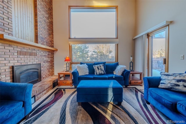 living room featuring a towering ceiling and a fireplace