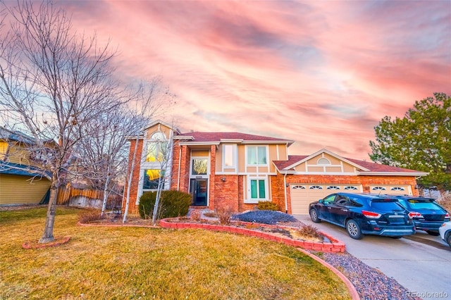 view of front of property with a yard and a garage