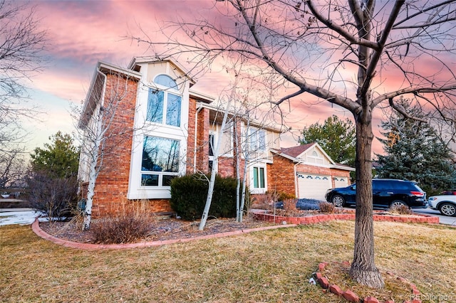 view of front of house featuring a garage and a yard