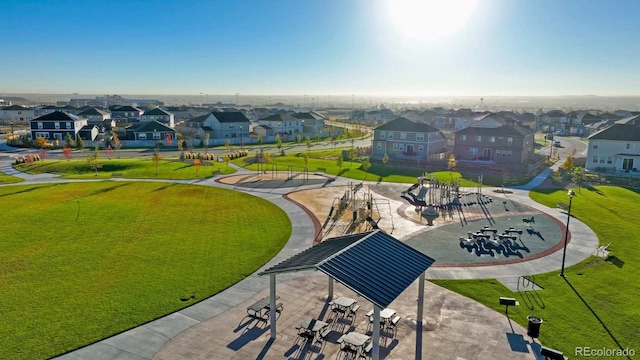 view of property's community featuring a residential view and a lawn
