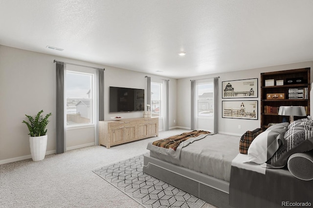 bedroom with baseboards and light carpet