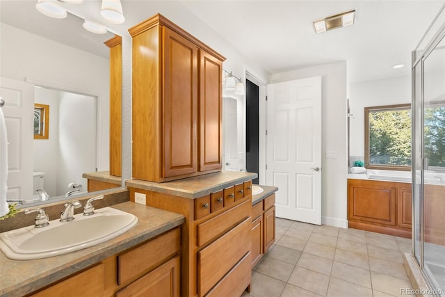 full bathroom featuring tile patterned flooring, vanity, shower with separate bathtub, and toilet