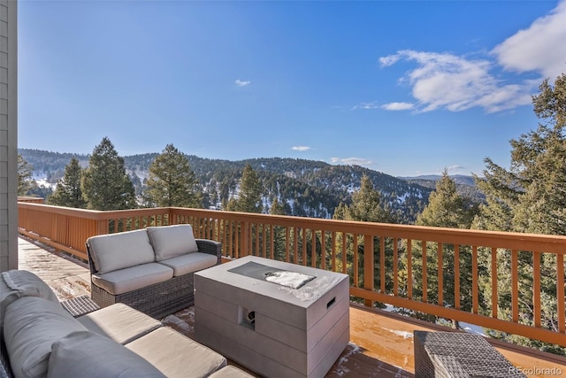 wooden terrace featuring an outdoor hangout area and a mountain view