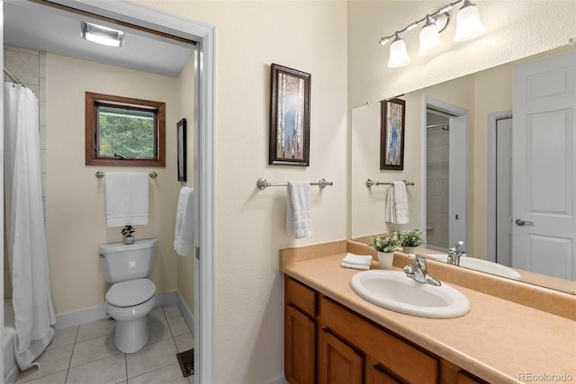 bathroom with tile patterned flooring, vanity, and toilet